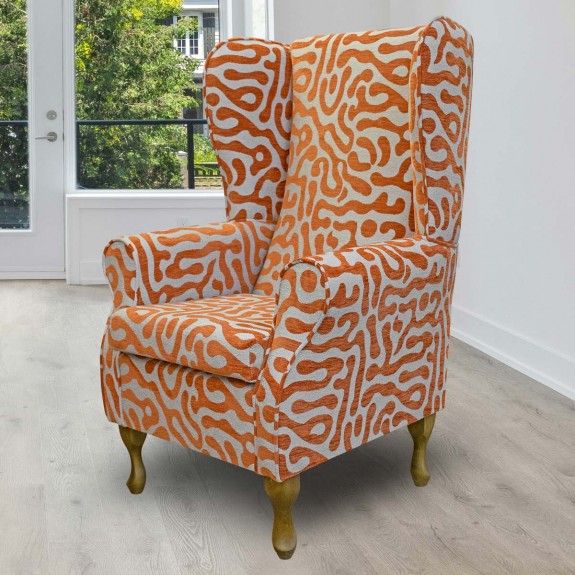 High back wing chair in orange patterned fabric