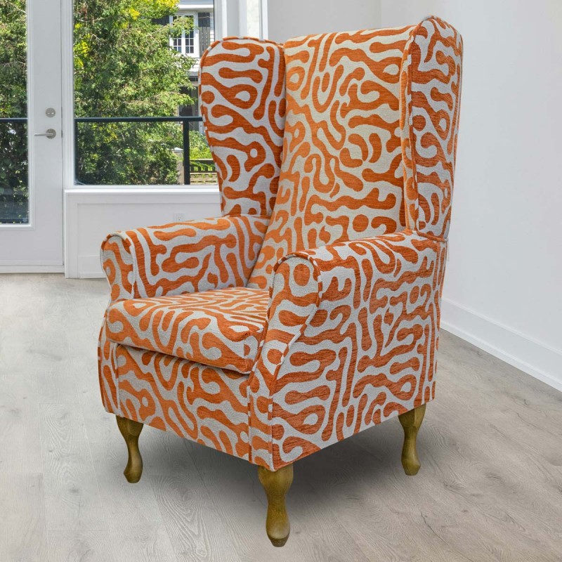 High back wing chair in orange patterned fabric High back wing chair in orange patterned fabric